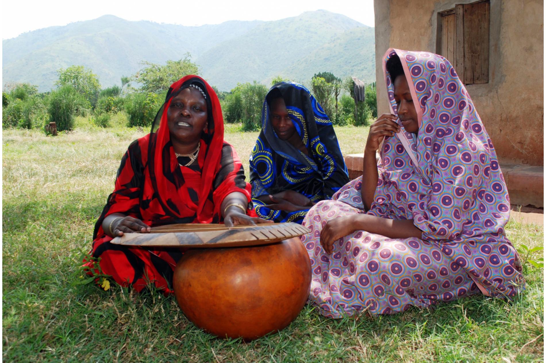 Mukancwanga from Busongora, near Lake George in western Uganda plays harp with her beautiful daughters-in-law.  She is an international award-winning harpist, invited by UNESCO to perform in Paris.